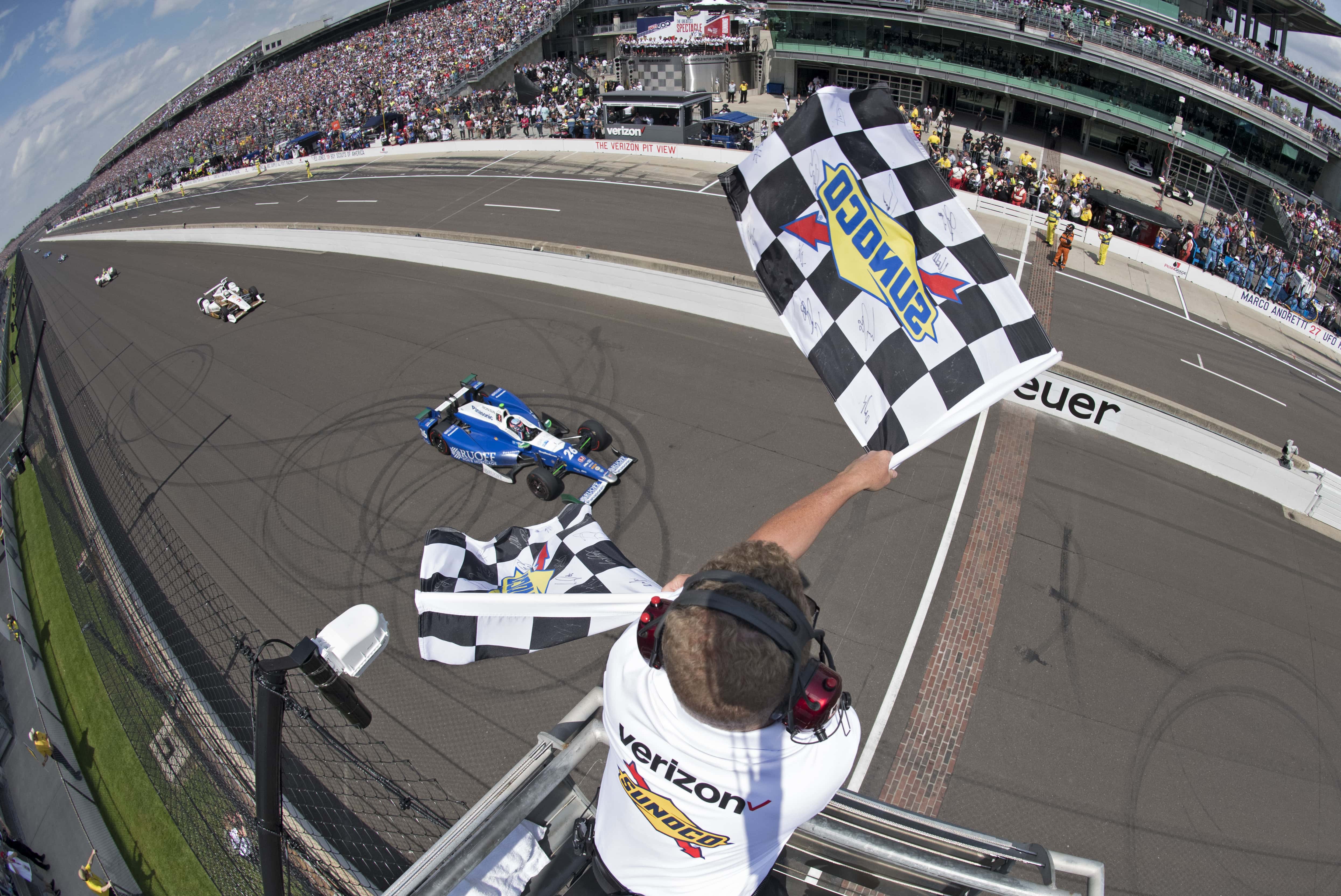 Takuma Sato crosses the finish line to win the Indianapolis 500.