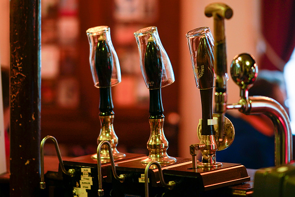 MANCHESTER, ENGLAND - OCTOBER 22: Empty pint glasses sit on the top of beer pumps of the Peveril Of The Peak pub, signifying they have been disconnected from the barrels ahead of new Tier-3 Covid-19 restrictions on October 22, 2020 in Manchester, England.