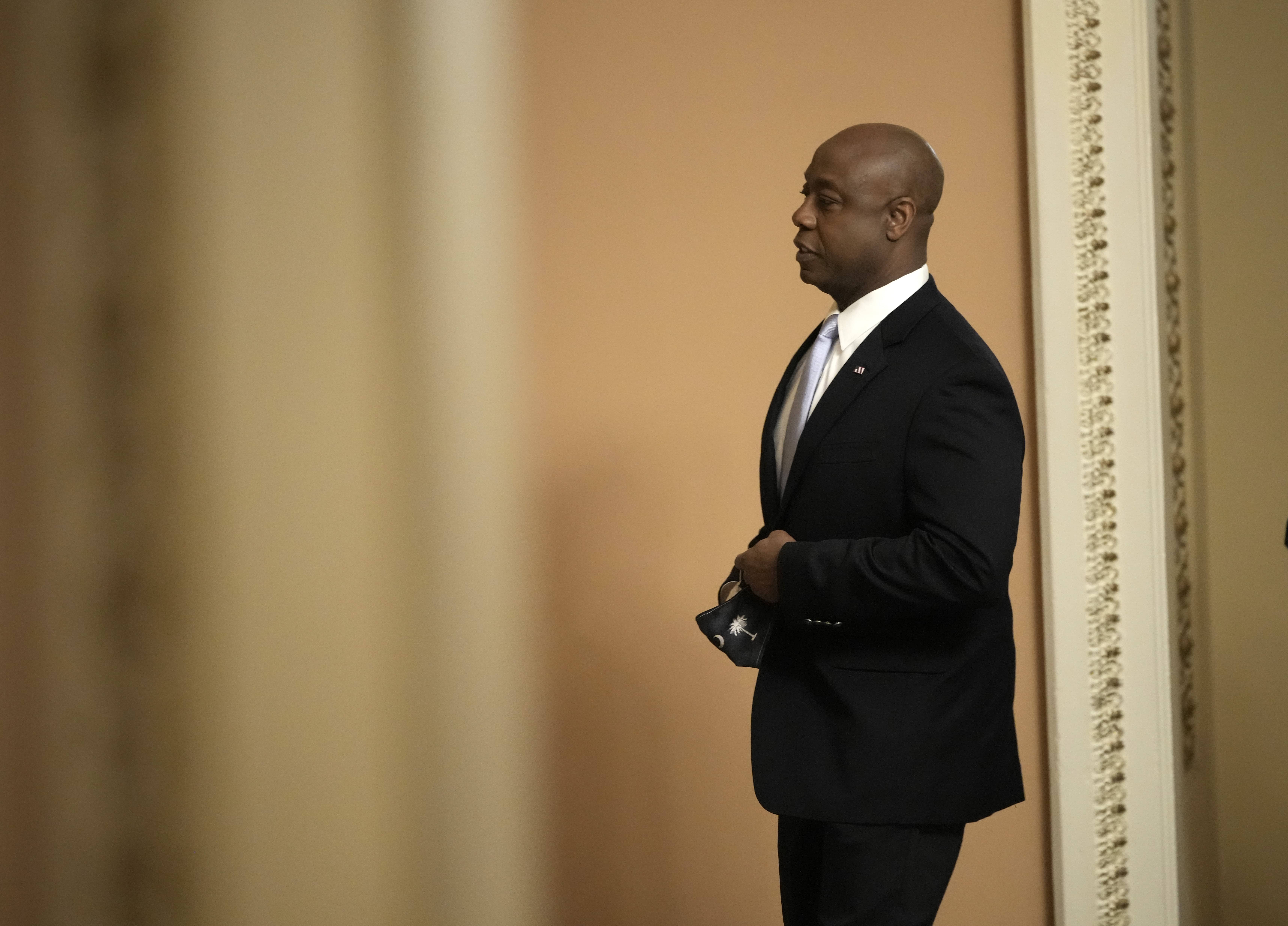 sen tim scott standing alone about to give GOP response