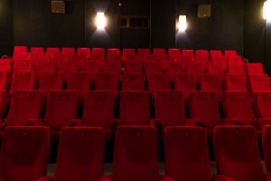 Rows of empty red cinema seats