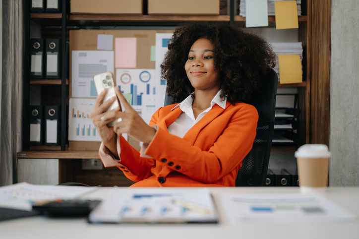 African Businesswoman using mobile phone, tablet. on blurred background