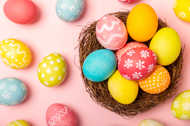 Easter eggs on a bright background. Easter celebration concept. Colorful easter handmade decorated Easter eggs. Place for text. Copy space.