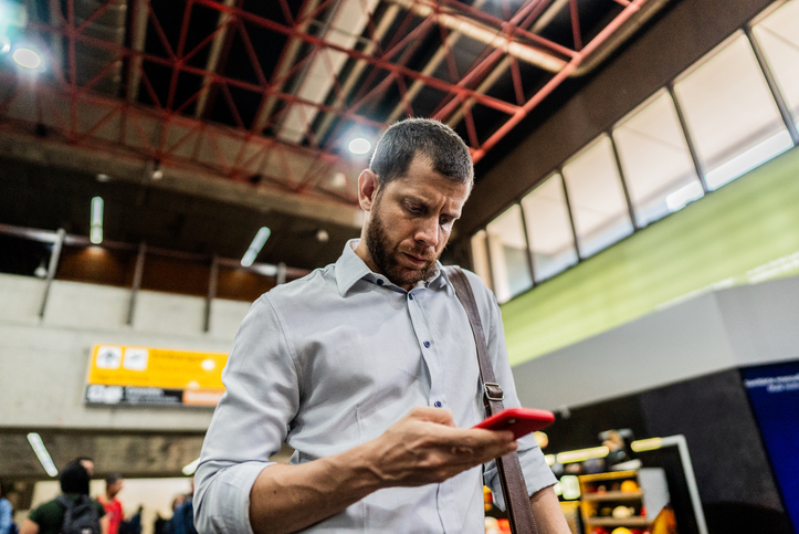 Businessman using the mobile phone at the airport