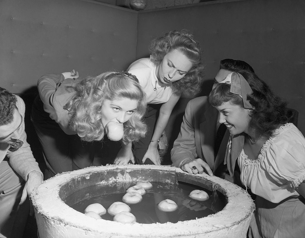 Teenagers Bobbing for Apples