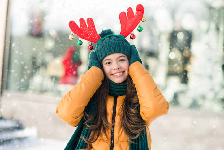 Photo of charming dreamy schoolgirl wear windbreaker jacket xmas deer hairband outside urban city street