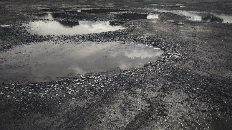Wheel tracks on damaged road