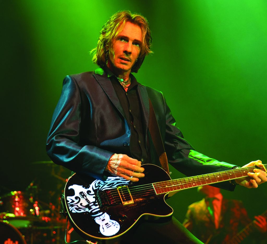 Concert picture of Rick Springfield. holding guitar. 2024_RS_Live Image RT