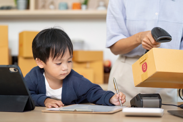 Child Engaging in Learning While Parent Works in Home Office