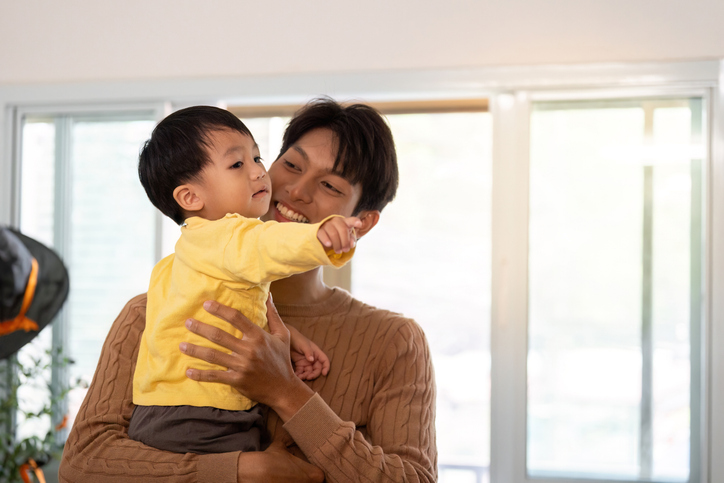 Father and Son. Playful interaction between dad and toddler in a cozy home setting.