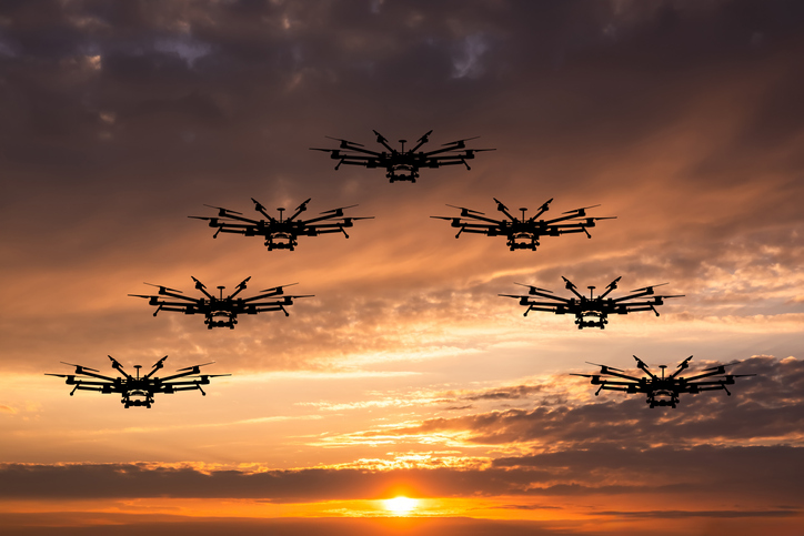 Group of drones against sunset sky
