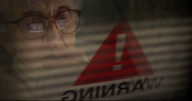 Senior woman internet fraud scam warning.