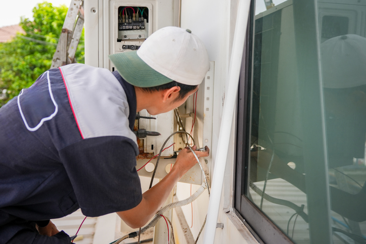 Repairman fix air conditioning systems, Male technician service for repair and maintenance of air conditioners