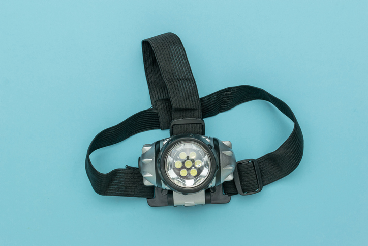 LED Headlamp on Blue Background: Essential Gear for Camping, Hiking, and Outdoor Adventures