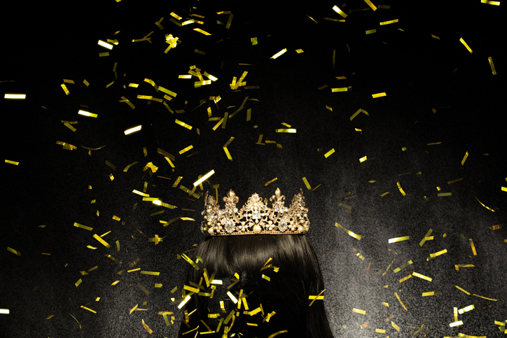 Gold Crown Diamond on hair wig model head. Sparking glitter diamond crown ready to put on winner wear head of Miss Beauty pageant contest. Black background isolated with aura stream